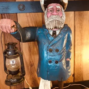 a statue of a sailor holding a lantern