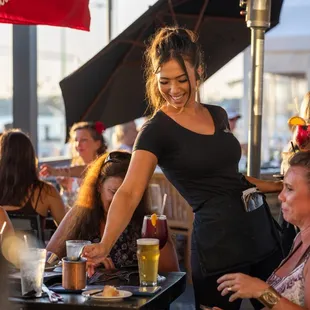 Service with a smile, because how can you not love that view. Servers enjoy working at Boathouse on the Bay
