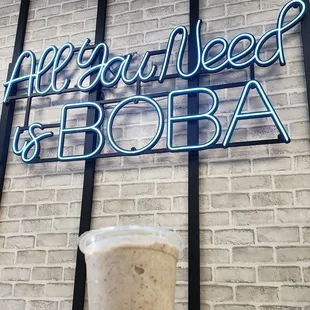 a hand holding a cup of boba