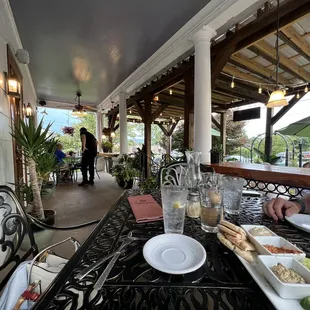 a woman sitting at a table with plates of food