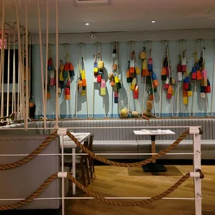 a room with a couch, a table, and a bunch of buoys