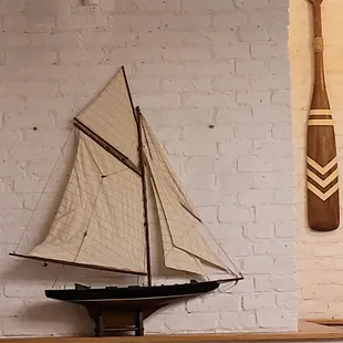 a model of a sailboat and a paddle