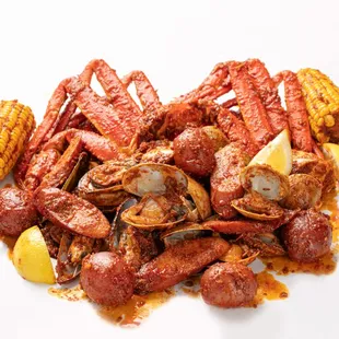 a pile of cooked crabs and corn