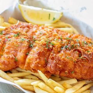 a basket of fried fish and french fries