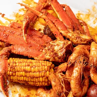 a plate of crab legs and corn on the cob