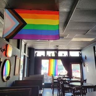a rainbow flag hanging from the ceiling