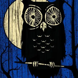 an owl perched on a branch in front of a full moon