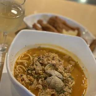 a bowl of soup and a glass of wine
