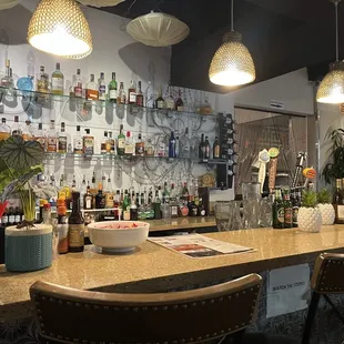 a bar with many bottles of alcohol