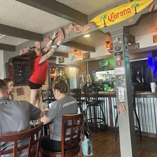 The waitress worked a few moments on the decor during the lunch hour in tight shorts and a tee-shirt.  Check out the leg and arm tats!