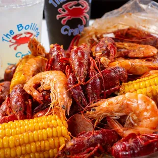 a plate of boiled shrimp and corn