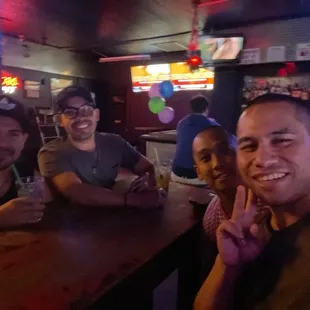 a group of people sitting at a bar