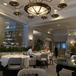 a dining room with a large chandelier