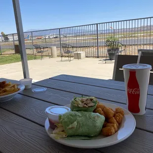 Chicken Cesar wrap and the run way outdoor seating