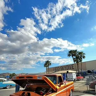 an orange truck with its hood open