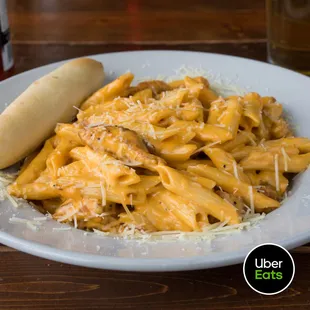 a plate of pasta and a hot dog