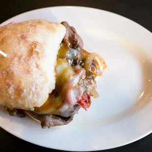a beef sandwich on a white plate