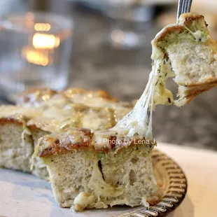 Focaccia ($12) - shallot herb butter, roasted garlic, parmesan, provolone