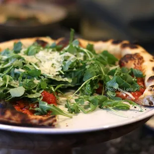Garlic Pizza ($20) - garlic cloves, Castelvetrano olives, arugula, pecorino