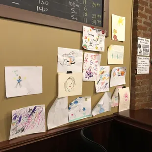A collection of art by local kiddos underneath the tap list