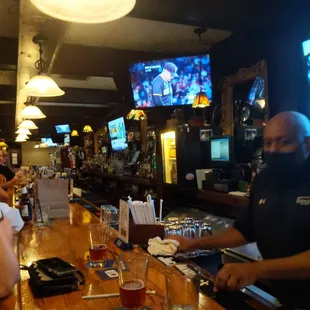 a bar with people sitting at the bar