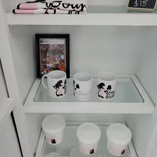 a shelf with cups and plates