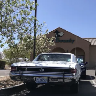 a white car parked in front of the restaurant