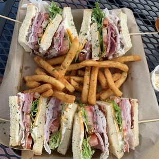 Bourbon Club Sandwich with seasoned fries.