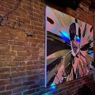 a man standing in front of a painting