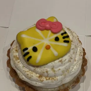 Lemon tart with a lemon cookie on top.