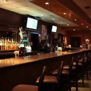 a bar with several televisions above it