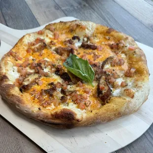 a pizza on a wooden board