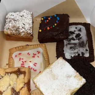 Cannoli crumb cake, cosmic brownie, lemon bar, cookies and cream pop tart, cherry pop tart, caramel bar, chocolate cream pie