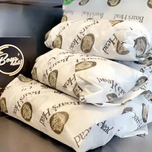 a stack of wrapped sandwiches