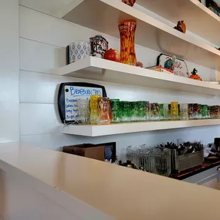 a kitchen with a counter and shelves