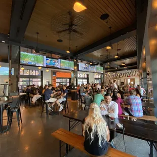 a large group of people sitting at tables in a restaurant