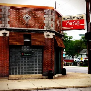 a brick building with a coca cola sign