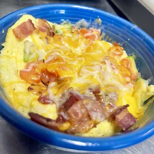 Breakfast bowl: eggs, bacon, tomatoes, avocado, cheese