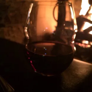 a glass of wine sitting on a table