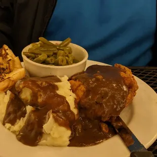 Smothered pork chops with mashed potatoes and southern green beans. Perfection!