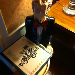 a statue of a man holding a menu