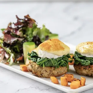 a plate with two sandwiches and a salad