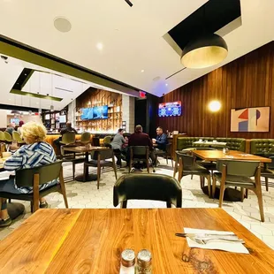 people sitting at tables in a restaurant