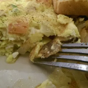 Skimpy razor thin sausage in the Greek omelette really, I think the fork is thicker.