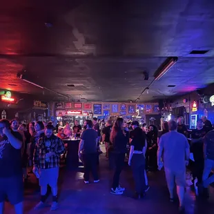 a crowd of people in a bar