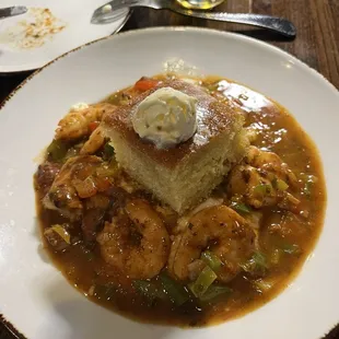 Sauteed Jumbo Shrimp and Grits Dinner with red Tasso ham gravy and corn biscuit on top.  Yum yum