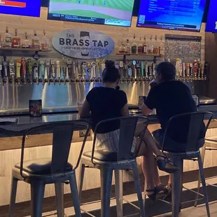 two people sitting at a bar