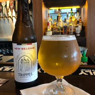 a glass of beer and a bottle of beer