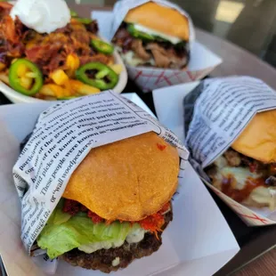 three burgers wrapped in paper