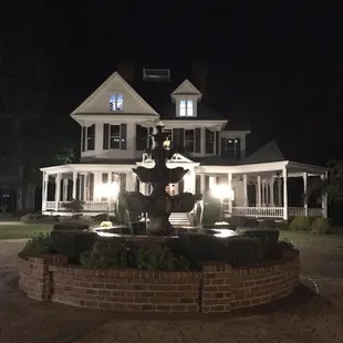 Plenty of parking, view from lot of house and fountain